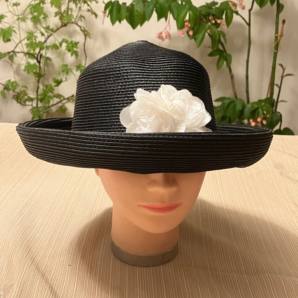 Elegant Black Hat with White Flower Accent
